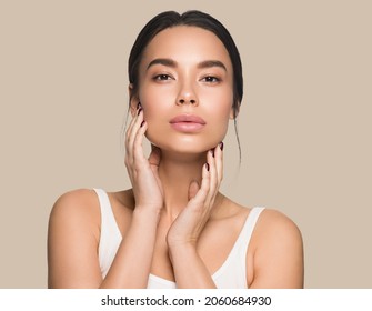 Beautiful Woman Close Up Face Asian Girl With Clean Fresh Healthy Skin. Color Background. Brown