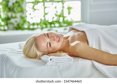 Beautiful woman with closed eyes getting a massage in the spa salon - Shutterstock ID 1547464463
