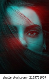 Beautiful woman cover her face with hair close-up fashion portrait in RGB color split. RGB effect make reflection of model face in red and blue colors. Abstract and futuristic looking style
