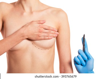 Beautiful woman covering her breast with sketches, surgeon in medical gloves is holding a scalpel, isolated on a white background, cropped