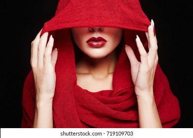 beautiful woman covers her face with a red cloth.red lips girl under hood.fashion islamic style woman