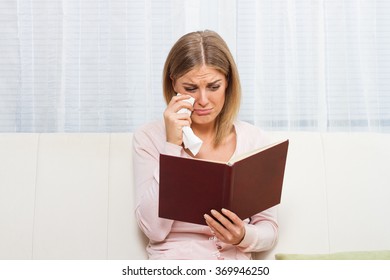 Beautiful woman is crying because she is reading very sad story.It's so sad story