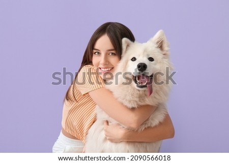 Beautiful woman with cute dog on color background