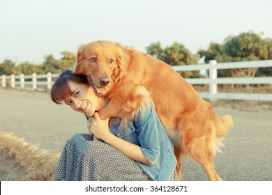 Beautiful Woman With A Cute Golden Retriever Dog