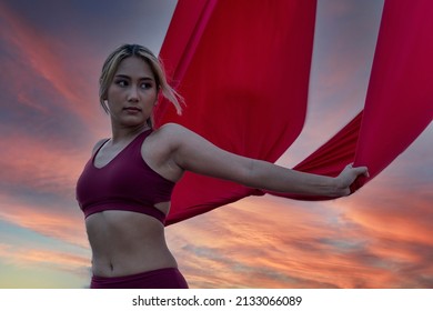 Beautiful Woman Dance With Aerial Silk On A Sky Background. Fly Yoga Sport
