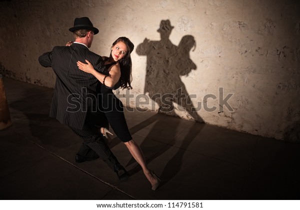 Beautiful woman with dance partner performing a\
tango routine