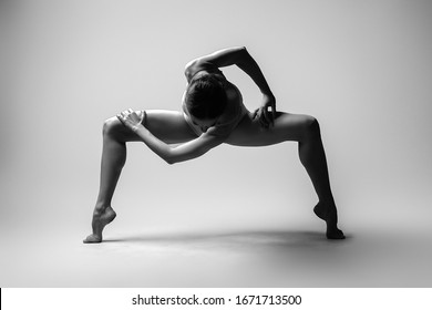 Beautiful woman dancer posing in studio. Flexible sexy woman. Black and white