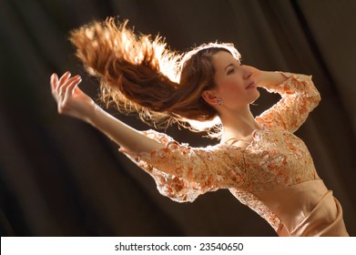 Beautiful woman dancing with hair flying