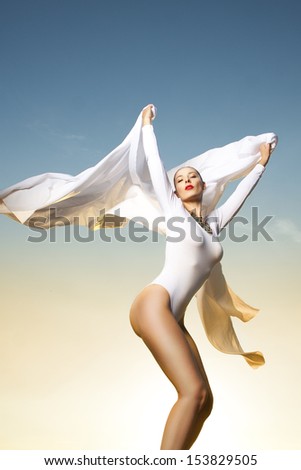 Beautiful woman dancing in sunlight 