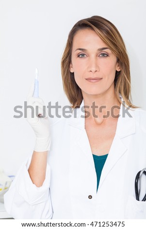beautiful woman doctor with a scalpel