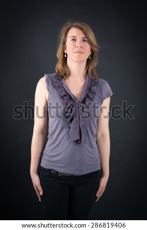 Beautiful woman doing different expressions in different sets of clothes: at attention