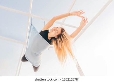 Beautiful Woman Doing Fly Yoga With Hammock. 