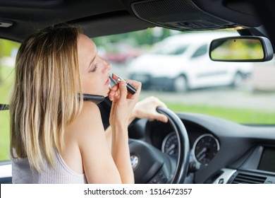 beautiful woman doing makeup in the car