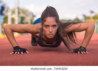 A Beautiful Woman Doing Push Up At A Park