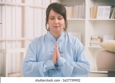 Beautiful Woman Doing Qi Gong Tai Chi Exercise At Home