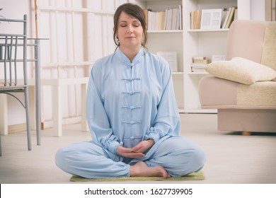 Beautiful Woman Doing Qi Gong Tai Chi Exercise At Home