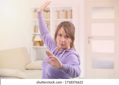 Beautiful Woman Doing Qi Gong Tai Chi Exercise At Home