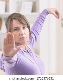 Beautiful Woman Doing Qi Gong Tai Chi Exercise At Home