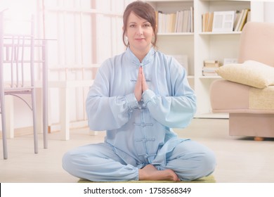 Beautiful Woman Doing Qi Gong Tai Chi Exercise At Home