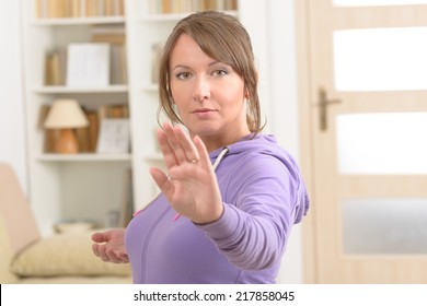 Beautiful Woman Doing Qi Gong Tai Chi Exercise At Home