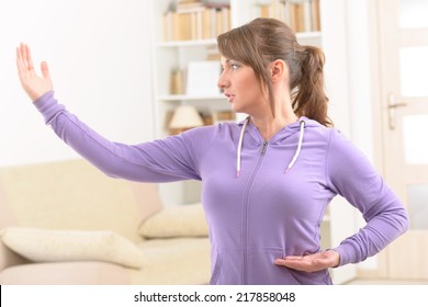 Beautiful Woman Doing Qi Gong Tai Chi Exercise At Home