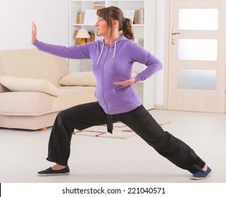 Beautiful Woman Doing Qi Gong Tai Chi Exercise At Home