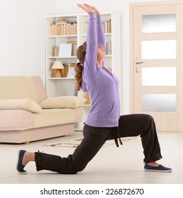 Beautiful Woman Doing Qi Gong Tai Chi Exercise At Home