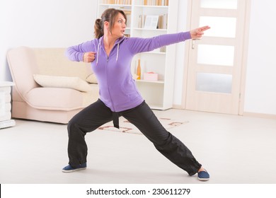 Beautiful Woman Doing Qi Gong Tai Chi Exercise At Home