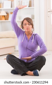 Beautiful Woman Doing Qi Gong Tai Chi Exercise At Home