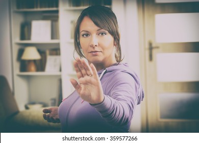 Beautiful Woman Doing Qi Gong Tai Chi Exercise At Home