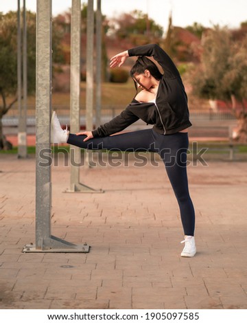 Similar – Young black woman doing stretching after running outdoors