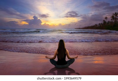 Beautiful woman doing yoga at the beach - Powered by Shutterstock