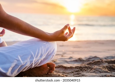 Beautiful woman doing yoga by the sea - Powered by Shutterstock