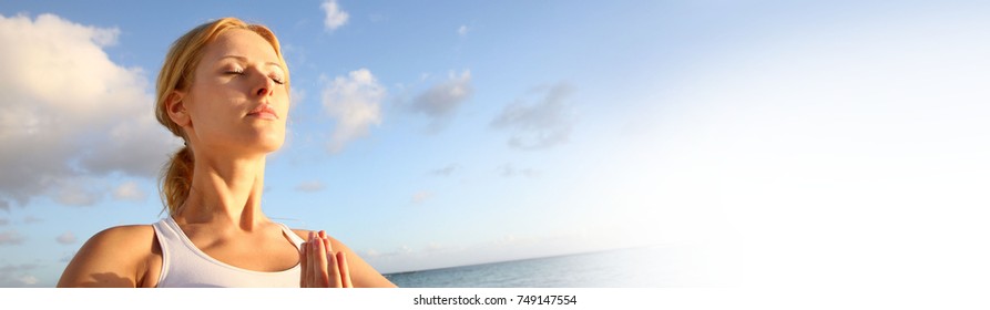 Beautiful woman doing yoga exercises by the beach - banner template web