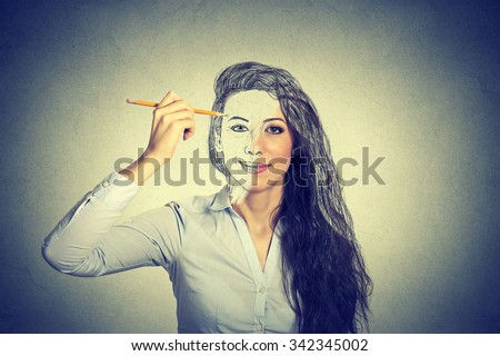 beautiful woman drawing self portrait with pencil 