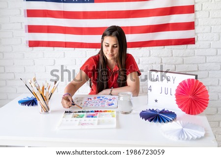 Beautiful woman drawing a watercolor illustration for Independence day of the USA
