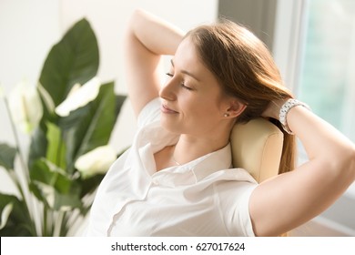 Beautiful Woman Dreaming With Closed Eyes In Office Chair. Businesswoman Feels Relaxed After Busy Working Day. Female Leaning Back In Chair With Hands Behind Head. Satisfied Girl Resting At Workplace 