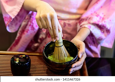 Beautiful woman dress in Kimono traditional Japanese long dress making green tea ,matcha
