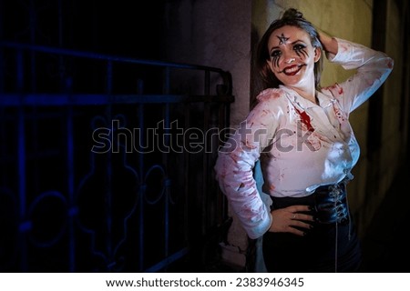 Beautiful woman dressed in a bloody shirt for Halloween