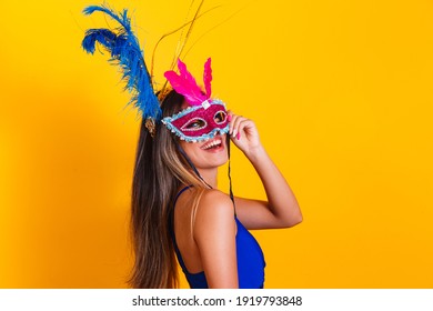 Beautiful woman dressed for the carnival night. Smiling woman ready to enjoy the carnival with mask