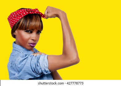 Beautiful woman dressed as the iconic Rosie the Riveter - Shutterstock ID 427778773