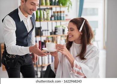 Beautiful woman drinking coffee in hair salon  - Powered by Shutterstock