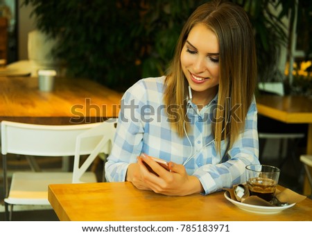 beautiful woman is drinking coffee and reading the morning news 