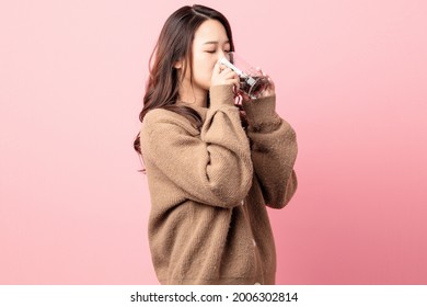 Beautiful Woman Drinking Coke On Pink Background