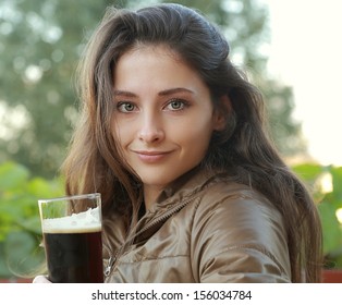 Beautiful Woman Drinking Dark Beer Outdoor Background. Closeup Portrait