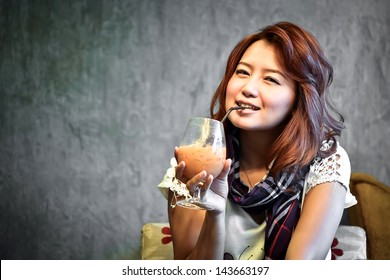 Beautiful Woman Is Drinking Ice Milk Tea In The Coffee Shop