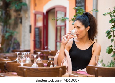 Beautiful Woman Drinking White Wine At Outdoor Cafe In Provence France