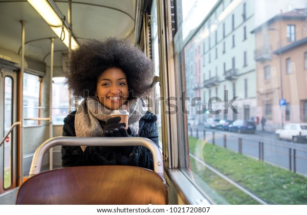 Beautiful woman driving on a bus - Afroamerican\
girl portrait\
outdoors
