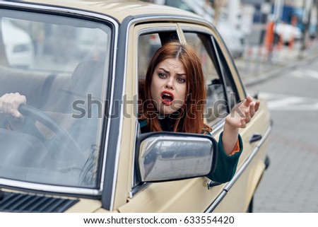 Beautiful woman driving retro car                               