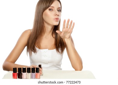 Beautiful Woman Drying Polished Nails Over White